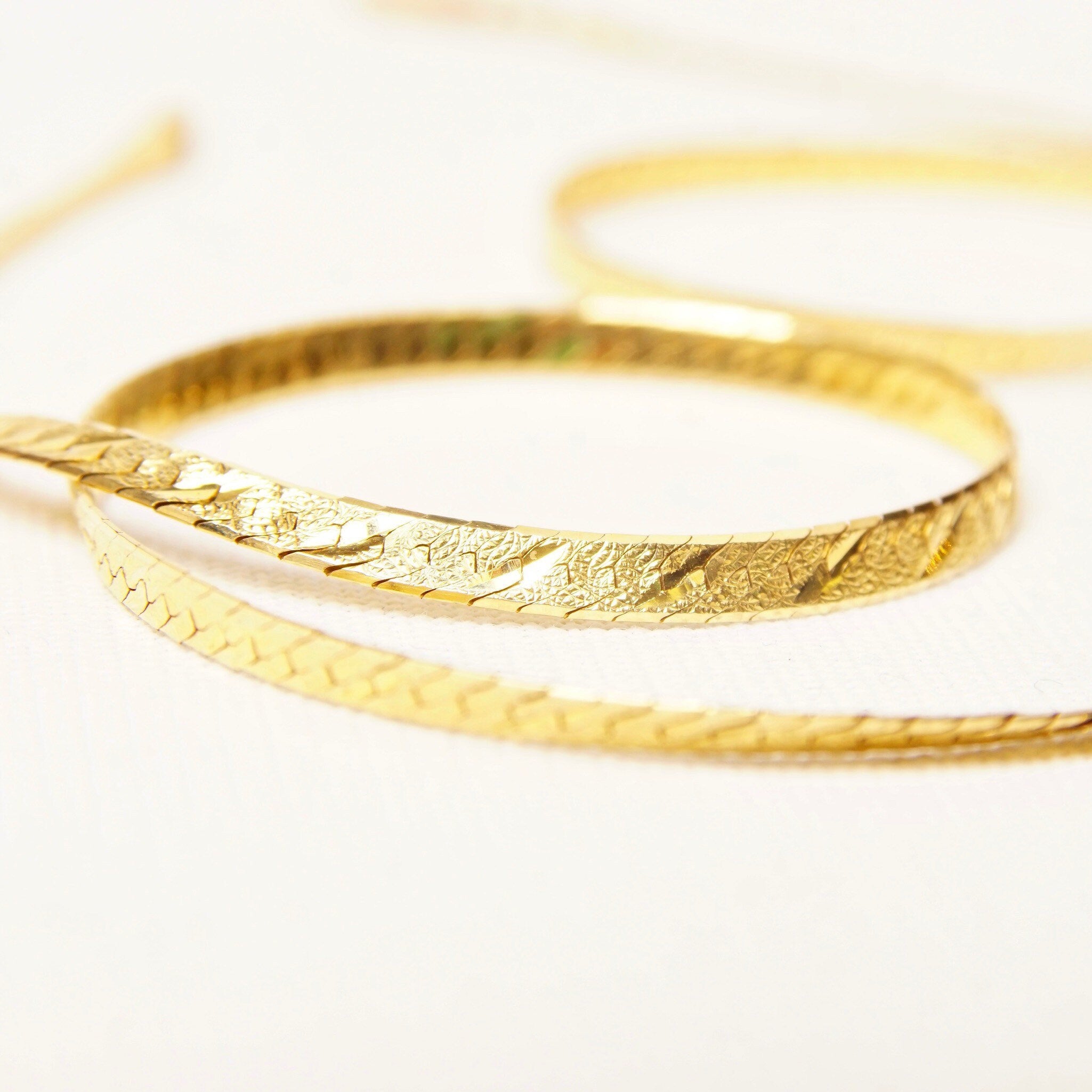 Italian 14K yellow gold diamond-cut herringbone chain necklace, 3.5mm wide, 20 inches long, showing texture and shine of the reversible solid gold links.
