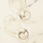 Vintage sterling silver hoop earrings with wrap around fish embellishments, lightweight small 925 silver tube hoops measuring 1 inch in diameter.