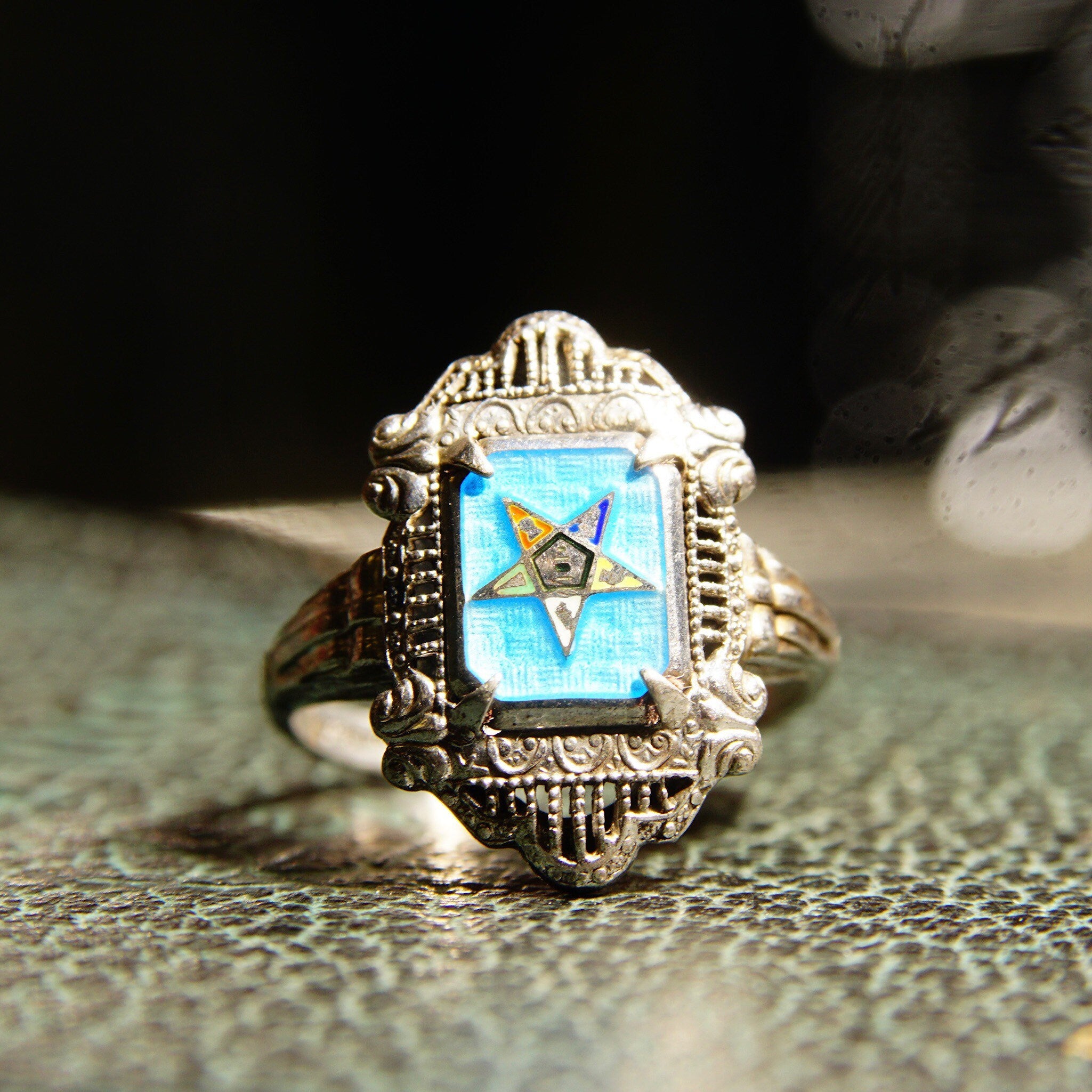 Vintage sterling silver filigree Order of the Eastern Star ring with blue and black enamel, featuring an intricate Art Deco design. Masonic his and her 925 silver jewelry from the early 20th century.