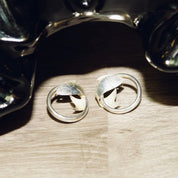 Vintage sterling silver fish hoop stud earrings on wooden surface, lightweight small 1" diameter tube hoops with wrap around fish embellishments, 925 silver
