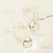 Vintage sterling silver hoop earrings with tube design and wrap-around fish embellishments, measuring 1 inch in diameter, lightweight 925 silver hoops with decorative fish details.
