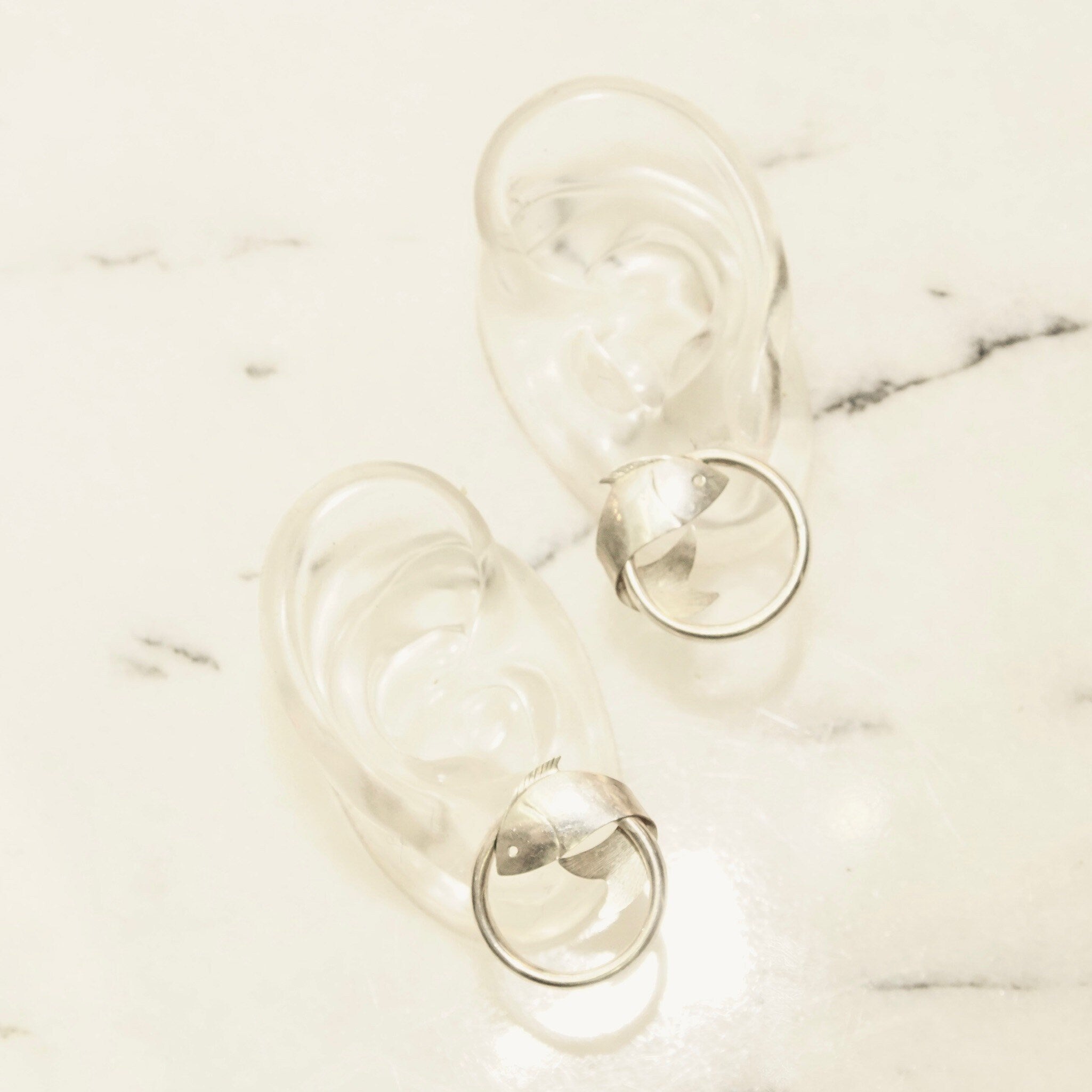 Vintage sterling silver hoop earrings with tube design and wrap-around fish embellishments, measuring 1 inch in diameter, lightweight 925 silver hoops with decorative fish details.