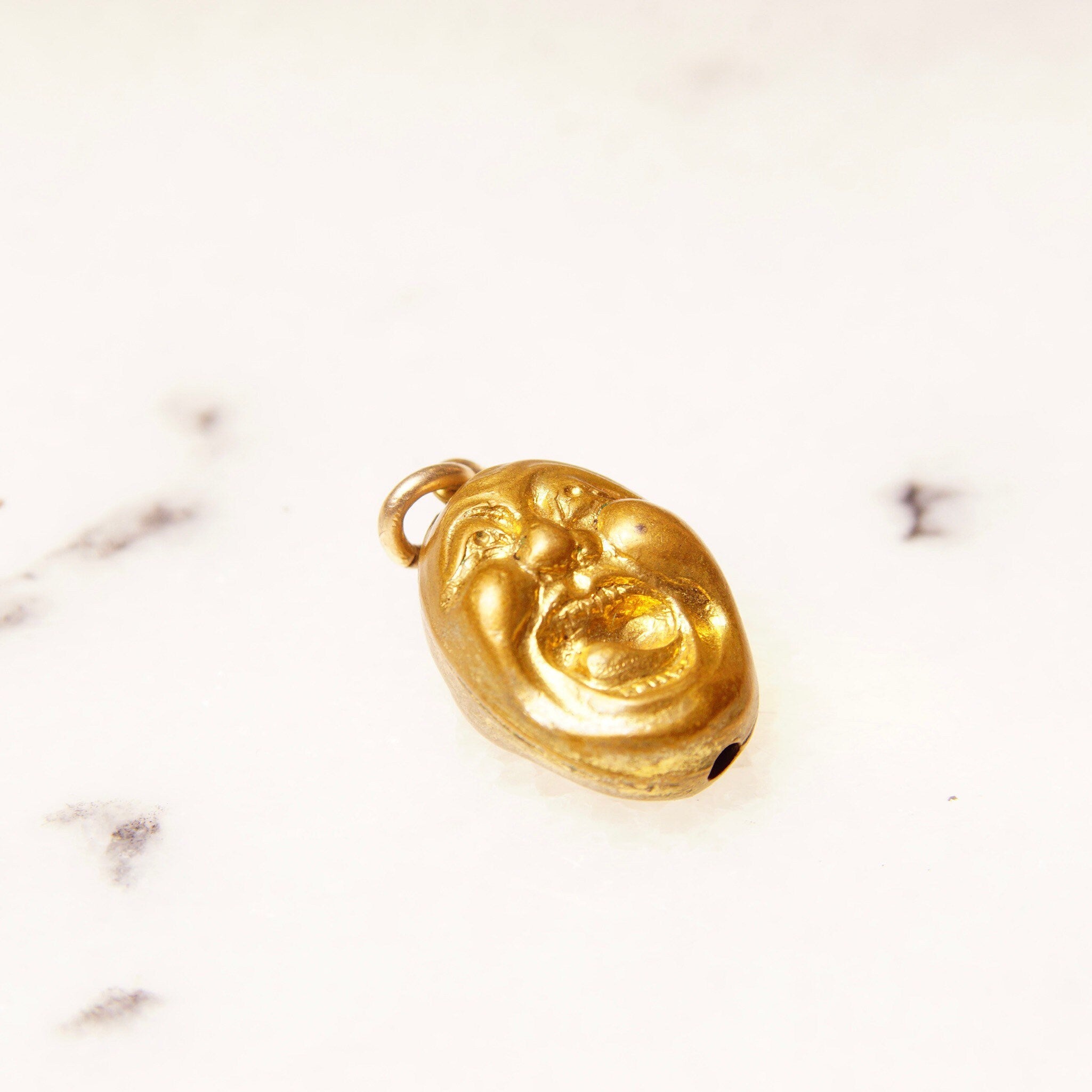 Vintage gold plated charms - yellow gold screaming face charm on white background