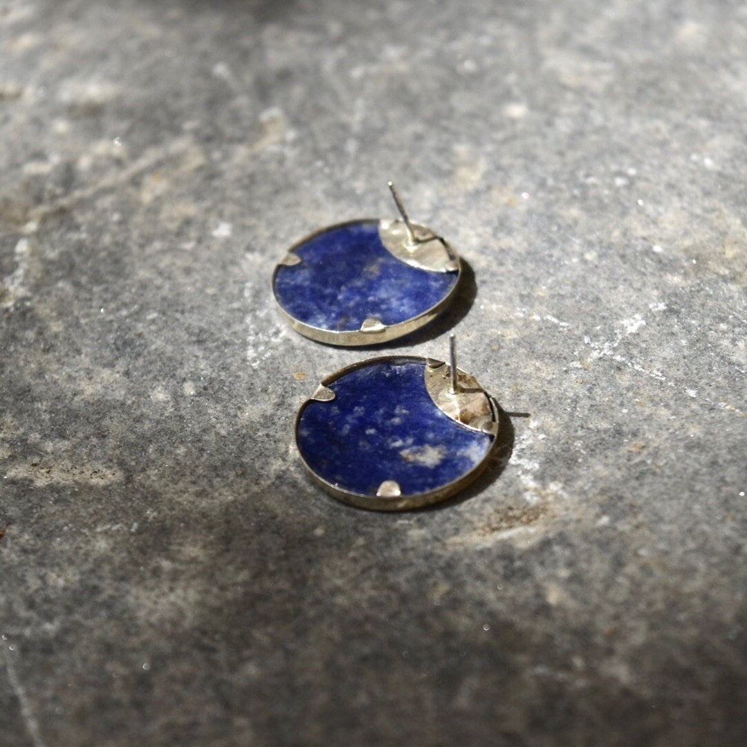 Vintage modernist sterling silver lapis lazuli yin-yang stud earrings on textured gray stone surface