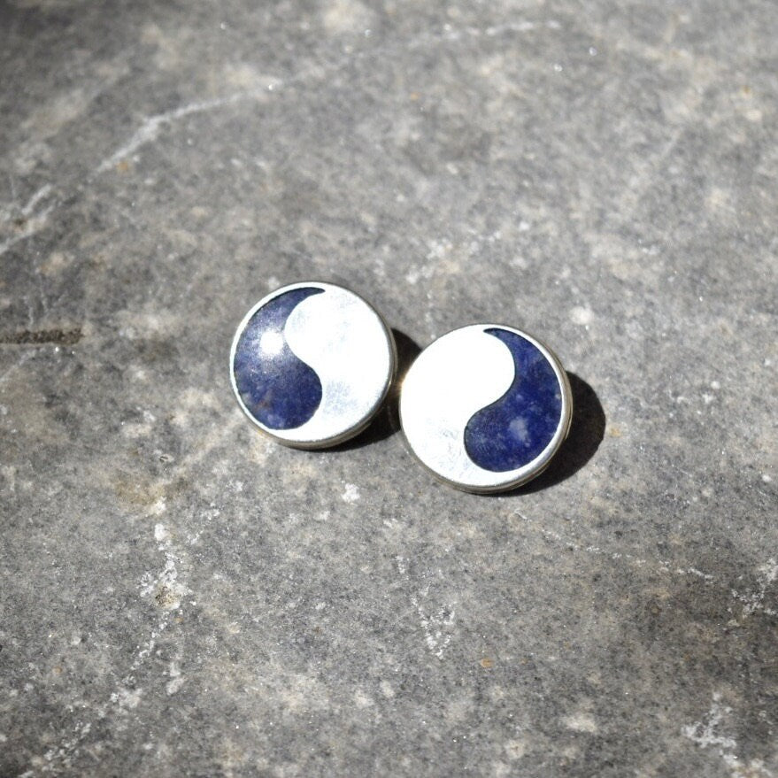 Vintage modernist sterling silver lapis lazuli yin-yang stud earrings on textured gray background