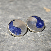 Vintage modernist sterling silver lapis lazuli yin-yang stud earrings on textured silver background