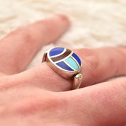 Vintage sterling silver flip ring with lapis lazuli, turquoise, and carnelian inlay stones, colorful scarab beetle fidget ring, size 8 US, on finger