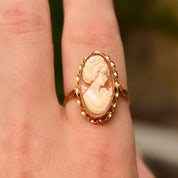 Vintage 10K Gold Cameo Ring with Classic Relief Shell Carving in an Elongated Oval Shape, featuring a Yellow Gold Ribbon Setting, shown on a finger, Size 10 US.
