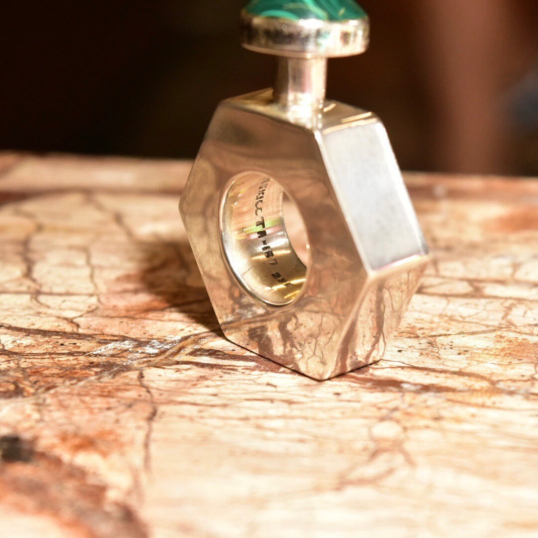 Vintage TAXCO modernist sterling silver hexagonal perfume bottle with malachite stone top, made in Mexico, measuring 2 inches tall.