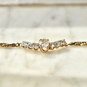 Alt text: 14K yellow gold diamond bar necklace with shared prong setting on a delicate 2mm Singapore chain, elegant 17 1/2 inch collar length