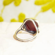 Sterling silver ring with carved black agate intaglio seal depicting a Roman warrior cameo, men's pinky ring size 6 US, shown on floral yellow background
