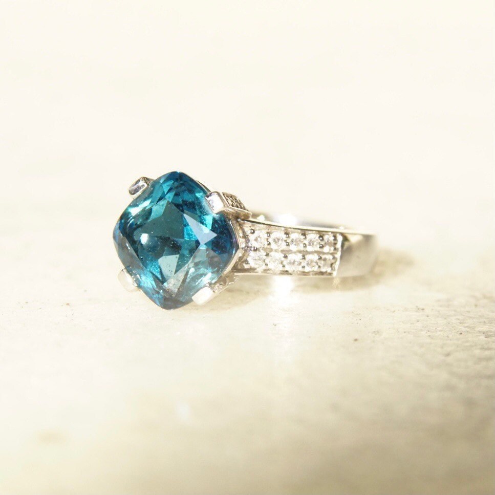Vintage 14K white gold blue topaz and diamond ring with cushion cut center stone in a cathedral setting, size 7.5.