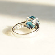 Vintage 14K white gold blue topaz and diamond cocktail ring with cushion cut gemstone in cathedral setting, size 7.5 US.