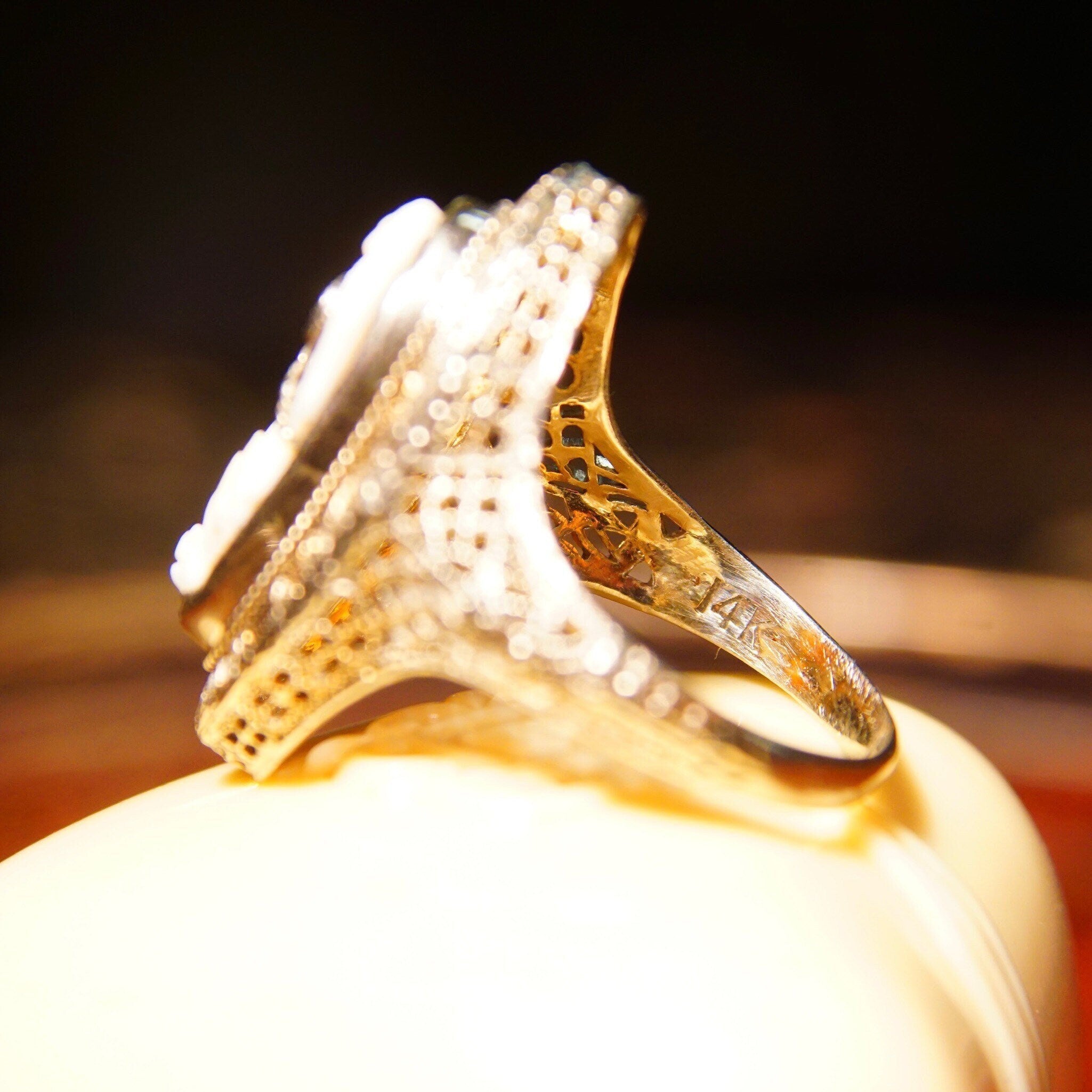 Antique 14K white gold filigree ring featuring a carved shell cameo depicting a woman's bust wearing a diamond necklace, with diamond accents on the setting, made by ESEMCO, size 6 1/4 US.