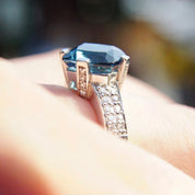 Vintage 14K white gold blue topaz and diamond cocktail ring featuring a cushion cut blue topaz gemstone in a cathedral setting accented with diamonds, size 7.5 US.