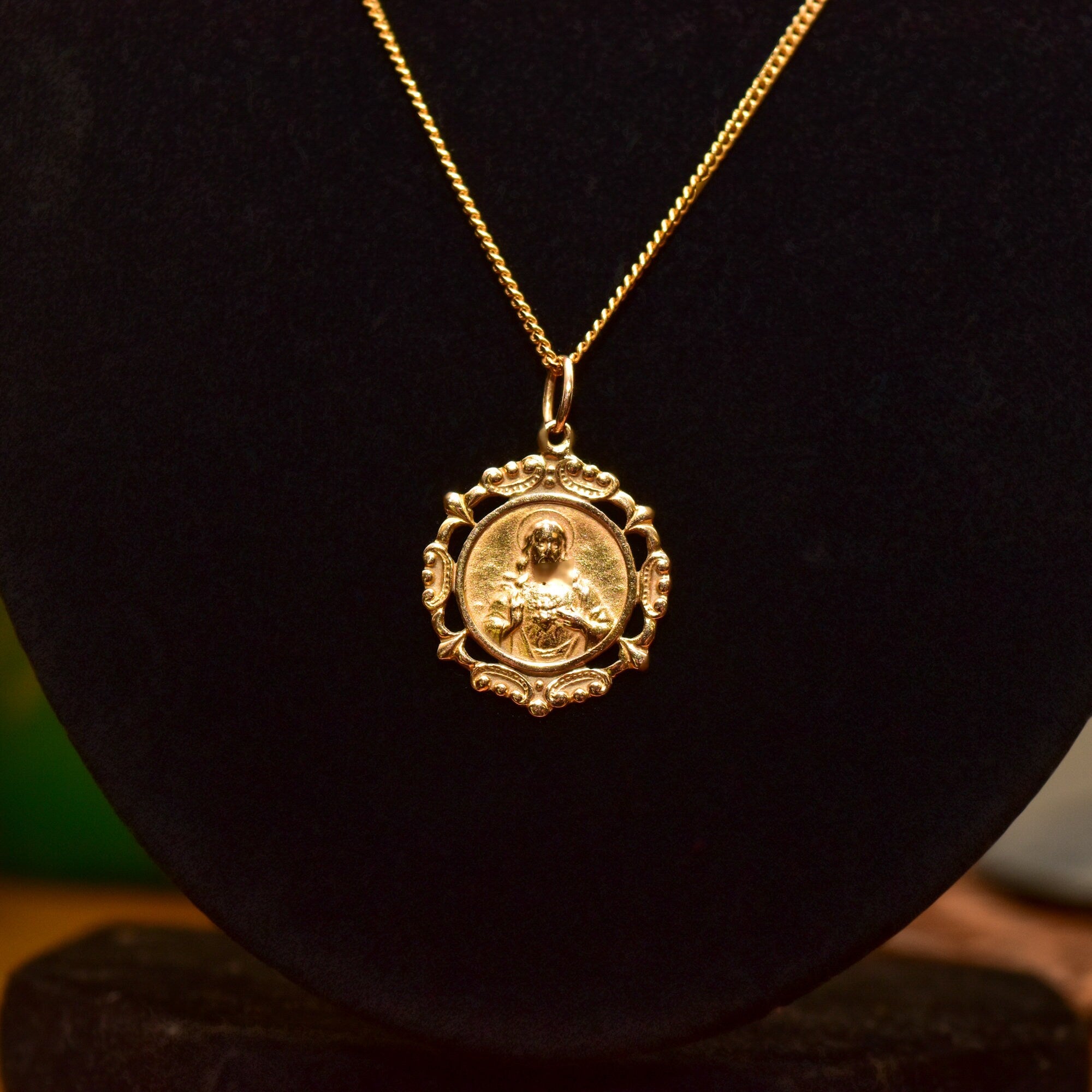 18K yellow gold Sacred Heart of Jesus pendant necklace with embossed religious medallion on a delicate 1.5mm curb chain, measuring 19 3/4 inches in length, showcasing intricate detailing and craftsmanship in a timeless piece of religious jewelry.