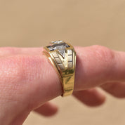 Two-tone 14K gold men's signet ring with diamond and sapphire in an engraved star setting, worn on finger, estate jewelry, size 12 US.