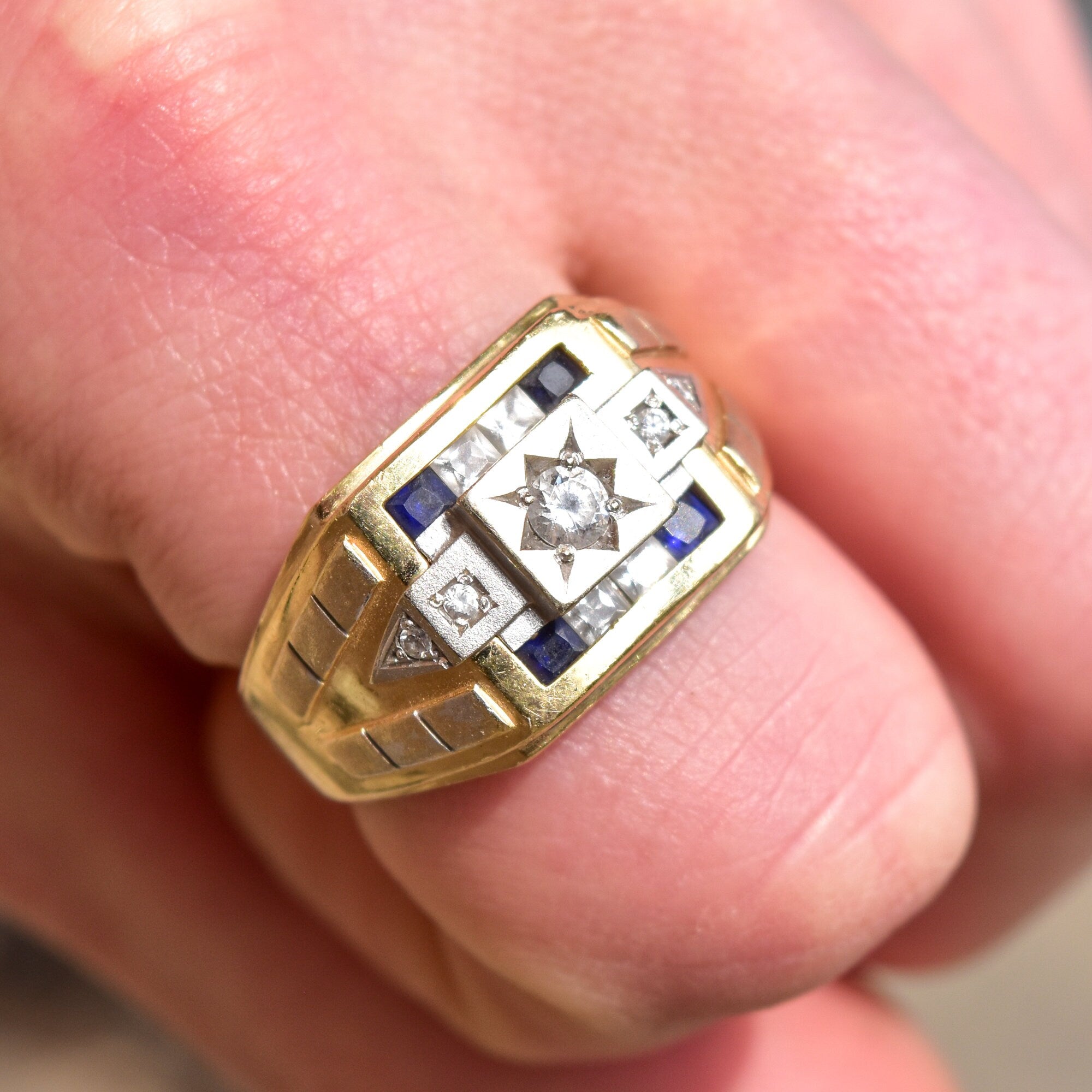 Men's 14K gold signet ring with diamond, sapphires, and engraved star design