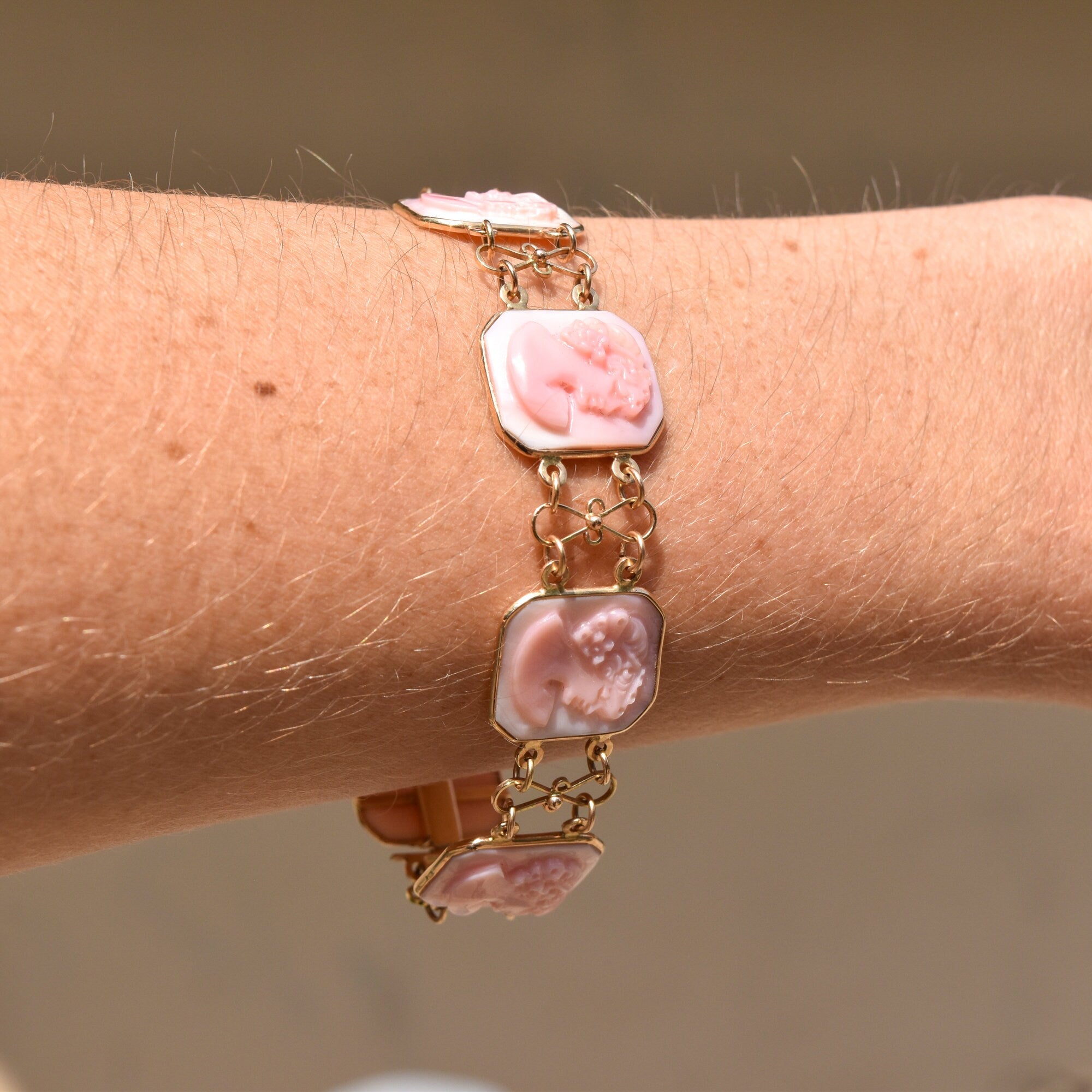 14K pink gold Italian cameo link bracelet featuring three carved shell cameos on a delicate chain, signed by M+M Scognamiglio, measuring 7 1/4 inches long, showcasing intricate estate jewelry craftsmanship.