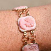 Antique Italian 14K gold pink shell cameo link bracelet with carved profiles on each link, signed by M+M SCOGNAMIGLIO, measuring 7 1/4 inches long.