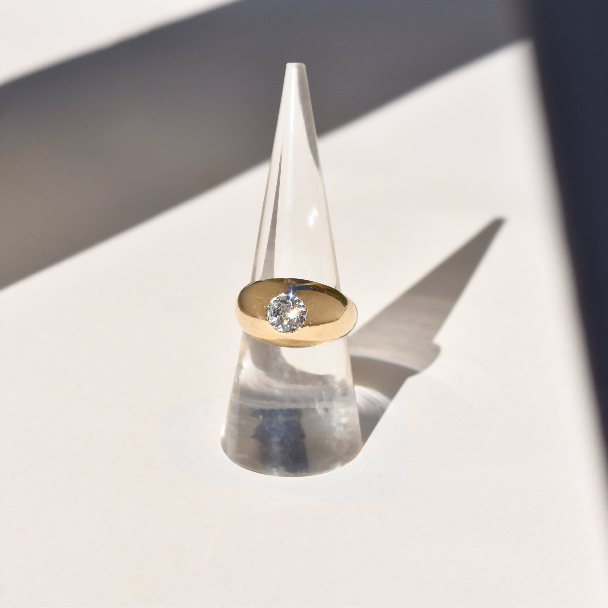 10K yellow gold Victorian solitaire paste dome ring, size 7, polished finish, antique wedding band with single round cut clear stone against plain light background