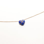 Tiffany & Co. 14K gold necklace with lapis lazuli heart cross pendant on a minimalist 18-inch chain against a white background